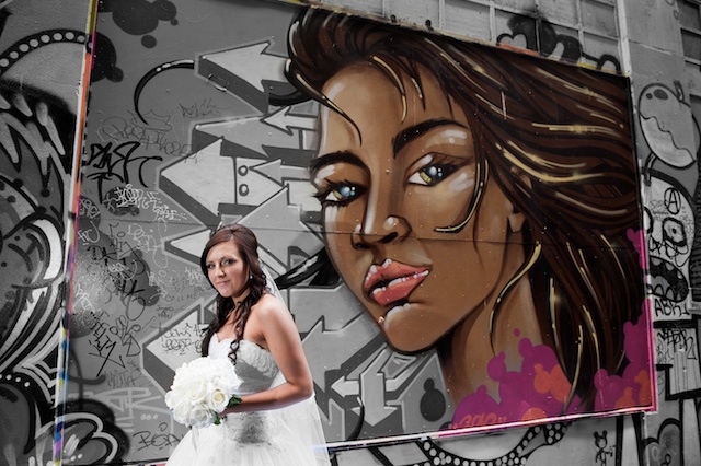 Melbourne Wedding Photographers captures this beautiful bridal portrait with a backdrop of graffiti art.