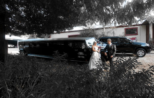 Wedding photography showing a bridal couple with a Hummer Stretch Limousine, at Forest Edge restaurant Gembrook.